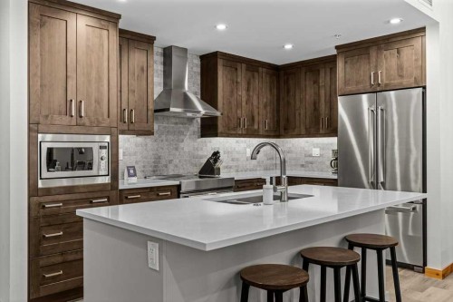 310B-1012 Spring Creek Drive West, Canmore, AB - Indoor Photo Showing Kitchen With Stainless Steel Kitchen With Upgraded Kitchen
