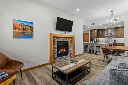 310B-1012 Spring Creek Drive West, Canmore, AB - Indoor Photo Showing Living Room With Fireplace