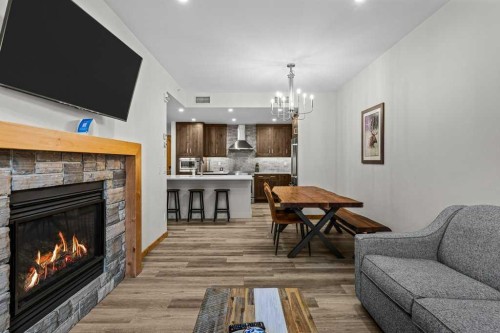 310B-1012 Spring Creek Drive West, Canmore, AB - Indoor Photo Showing Living Room With Fireplace