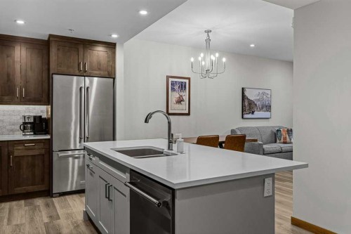 310B-1012 Spring Creek Drive West, Canmore, AB - Indoor Photo Showing Kitchen With Stainless Steel Kitchen With Double Sink With Upgraded Kitchen