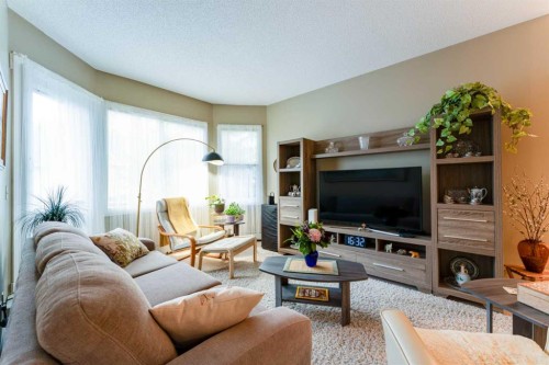 206-8 Prestwick Pond Terrace Se, Calgary, AB - Indoor Photo Showing Living Room