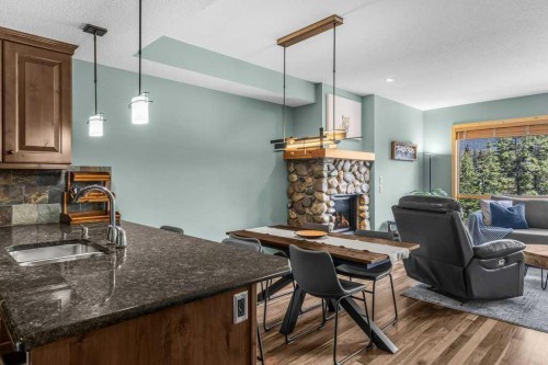 310-600 Spring Creek Drive, Canmore, AB - Indoor With Fireplace