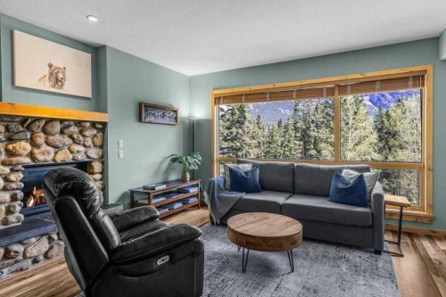 310-600 Spring Creek Drive, Canmore, AB - Indoor Photo Showing Living Room With Fireplace