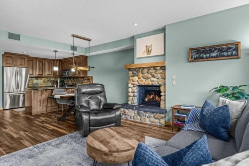 310-600 Spring Creek Drive, Canmore, AB - Indoor Photo Showing Other Room With Fireplace
