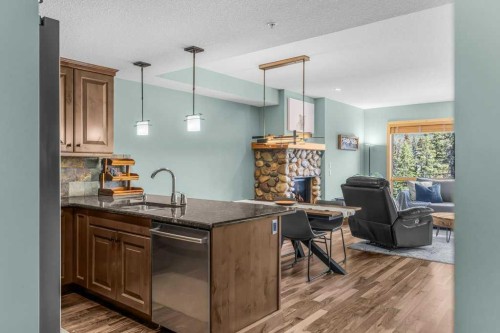 310-600 Spring Creek Drive, Canmore, AB - Indoor With Fireplace