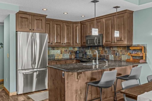 310-600 Spring Creek Drive, Canmore, AB - Indoor Photo Showing Kitchen With Stainless Steel Kitchen