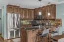 310-600 Spring Creek Drive, Canmore, AB  - Indoor Photo Showing Kitchen With Stainless Steel Kitchen 