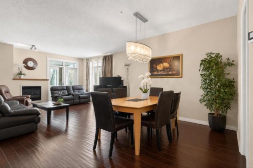 7305-14 Hemlock Crescent Sw, Calgary, AB - Indoor Photo Showing Dining Room With Fireplace