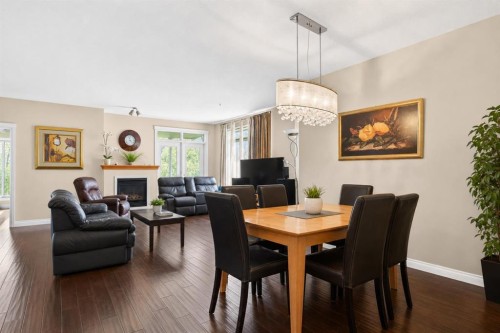 7305-14 Hemlock Crescent Sw, Calgary, AB - Indoor Photo Showing Dining Room With Fireplace