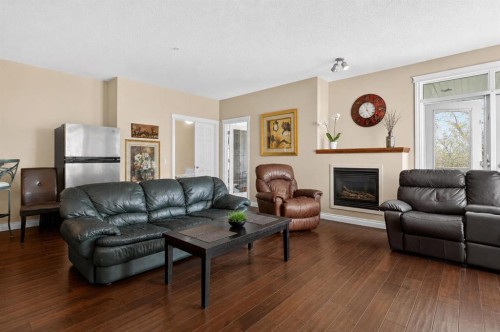 7305-14 Hemlock Crescent Sw, Calgary, AB - Indoor Photo Showing Living Room With Fireplace