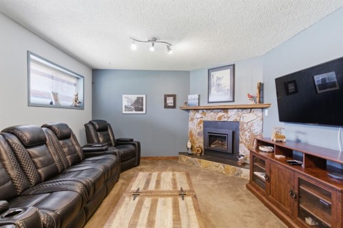 5012 Valiant Drive Nw, Calgary, AB - Indoor Photo Showing Living Room With Fireplace
