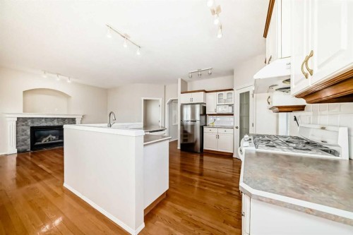 68 Scenic View Close Nw, Calgary, AB - Indoor Photo Showing Kitchen With Fireplace
