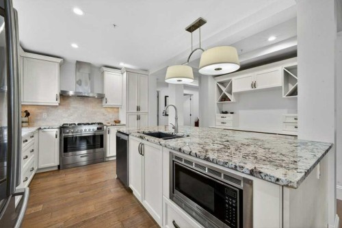 107-121 Quarry Way Se, Calgary, AB - Indoor Photo Showing Kitchen With Stainless Steel Kitchen With Double Sink With Upgraded Kitchen