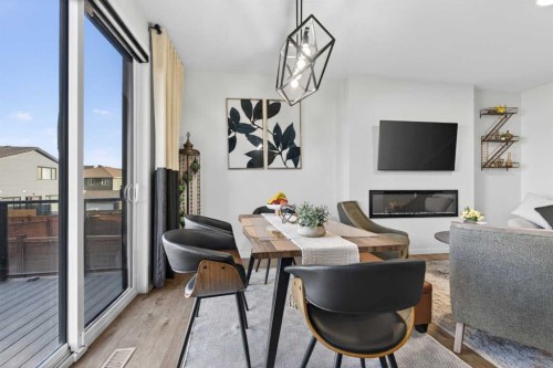 36 Royston Rise Nw, Calgary, AB - Indoor Photo Showing Dining Room With Fireplace