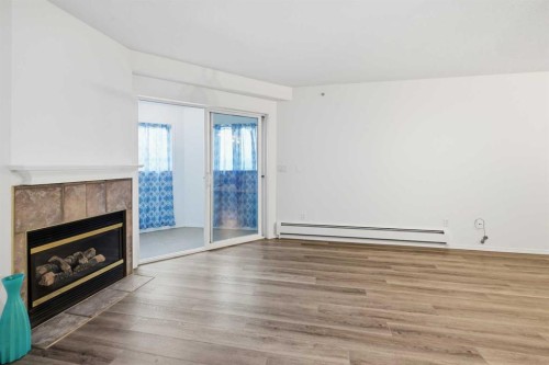 439-165 Manora Place Ne, Calgary, AB - Indoor Photo Showing Living Room With Fireplace