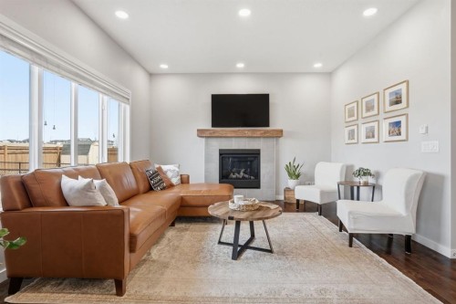81 Mount Rae Heights, Okotoks, AB - Indoor Photo Showing Living Room With Fireplace