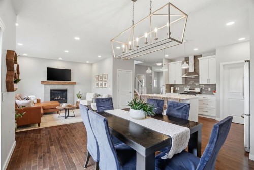 81 Mount Rae Heights, Okotoks, AB - Indoor Photo Showing Dining Room With Fireplace