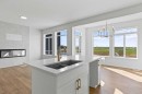 131 Corner Glen Grove Ne, Calgary, AB  - Indoor Photo Showing Kitchen With Fireplace With Double Sink 