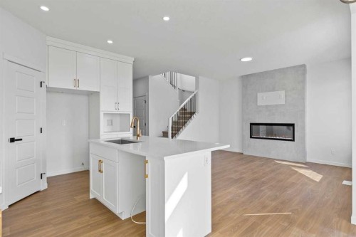 131 Corner Glen Grove Ne, Calgary, AB - Indoor Photo Showing Kitchen With Fireplace