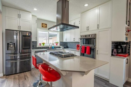 110 Hillcrest Close Sw, Airdrie, AB - Indoor Photo Showing Kitchen With Stainless Steel Kitchen