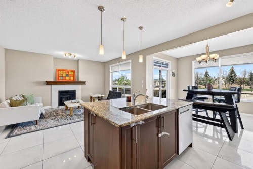 71 Walden Manor Se, Calgary, AB - Indoor Photo Showing Kitchen With Fireplace With Double Sink