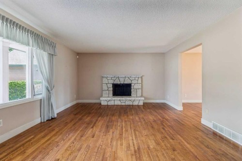 1207 Baldwin Crescent Sw, Calgary, AB - Indoor Photo Showing Living Room With Fireplace