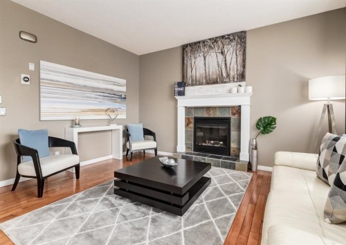 124 Copperfield Green Se, Calgary, AB - Indoor Photo Showing Living Room With Fireplace