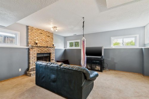 34 Shawfield Place Sw, Calgary, AB - Indoor Photo Showing Other Room With Fireplace