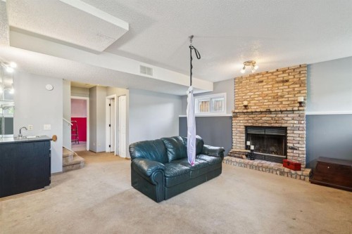 34 Shawfield Place Sw, Calgary, AB - Indoor Photo Showing Living Room With Fireplace