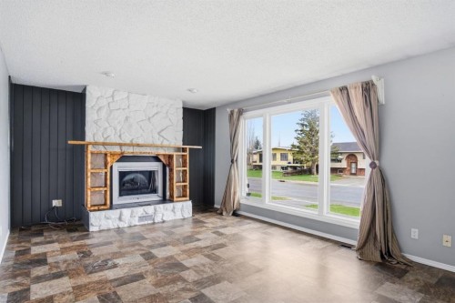 4525 Shannon Drive, Olds, AB - Indoor Photo Showing Living Room With Fireplace