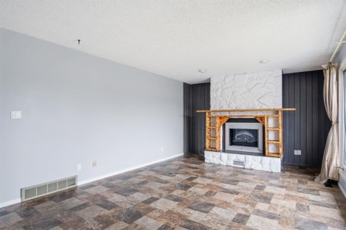 4525 Shannon Drive, Olds, AB - Indoor Photo Showing Living Room With Fireplace