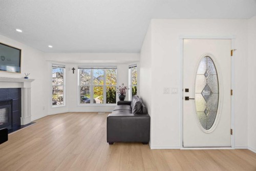 176 Arbour Grove Close Nw, Calgary, AB - Indoor Photo Showing Living Room With Fireplace