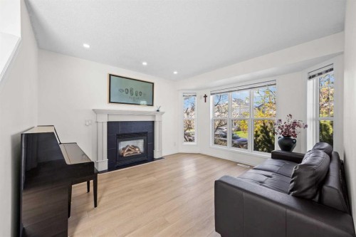 176 Arbour Grove Close Nw, Calgary, AB - Indoor Photo Showing Living Room With Fireplace