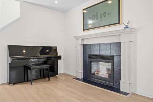 176 Arbour Grove Close Nw, Calgary, AB - Indoor Photo Showing Living Room With Fireplace