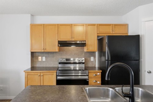 80 Prestwick Bay Se, Calgary, AB - Indoor Photo Showing Kitchen With Double Sink