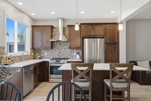 58 Kingfisher Crescent Se, Airdrie, AB - Indoor Photo Showing Kitchen With Stainless Steel Kitchen With Upgraded Kitchen