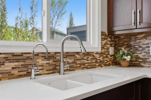 58 Kingfisher Crescent Se, Airdrie, AB - Indoor Photo Showing Kitchen With Double Sink