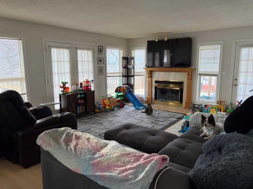 1065 East Chestermere Drive, Chestermere, AB - Indoor Photo Showing Living Room With Fireplace
