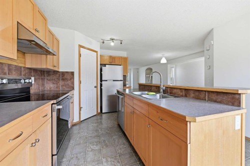 169 Cranberry Square Se, Calgary, AB - Indoor Photo Showing Kitchen With Double Sink