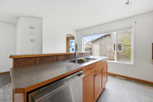 169 Cranberry Square Se, Calgary, AB - Indoor Photo Showing Kitchen With Double Sink