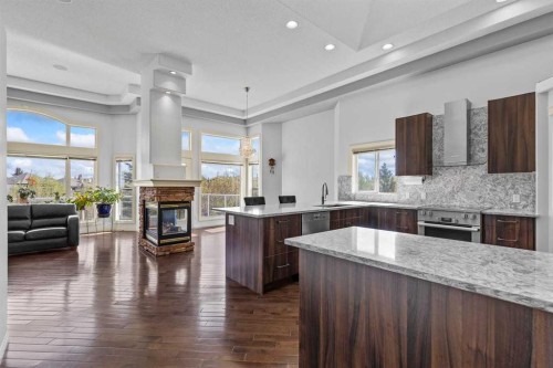 72 Strathlea Place Sw, Calgary, AB - Indoor Photo Showing Kitchen With Fireplace With Upgraded Kitchen