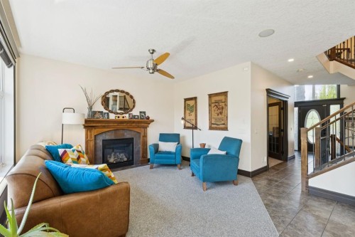 957 Coopers Drive Sw, Airdrie, AB - Indoor Photo Showing Living Room With Fireplace