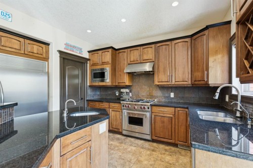 957 Coopers Drive Sw, Airdrie, AB - Indoor Photo Showing Kitchen With Double Sink