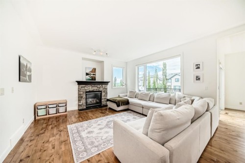 35 Sunset View, Cochrane, AB - Indoor Photo Showing Living Room With Fireplace
