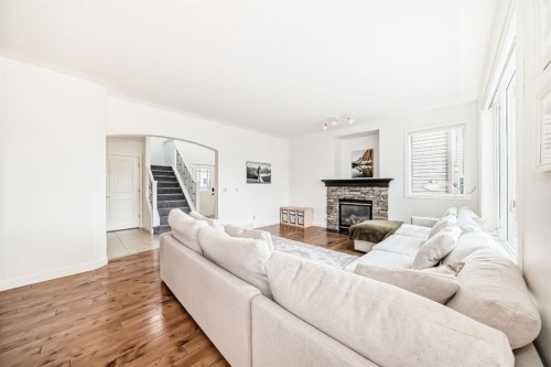 35 Sunset View, Cochrane, AB - Indoor Photo Showing Living Room With Fireplace
