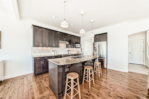 35 Sunset View, Cochrane, AB - Indoor Photo Showing Kitchen With Stainless Steel Kitchen With Double Sink With Upgraded Kitchen