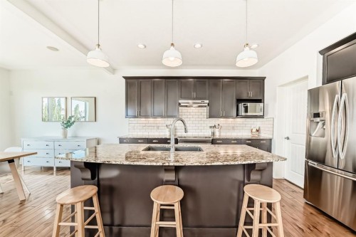 35 Sunset View, Cochrane, AB - Indoor Photo Showing Kitchen With Stainless Steel Kitchen With Double Sink With Upgraded Kitchen