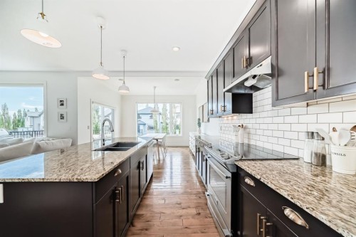 35 Sunset View, Cochrane, AB - Indoor Photo Showing Kitchen With Double Sink With Upgraded Kitchen