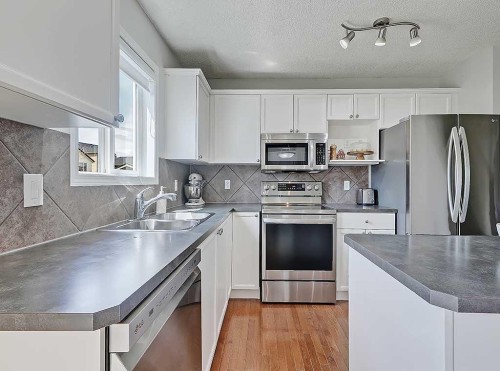 558 Evermeadow Road Sw, Calgary, AB - Indoor Photo Showing Kitchen With Double Sink