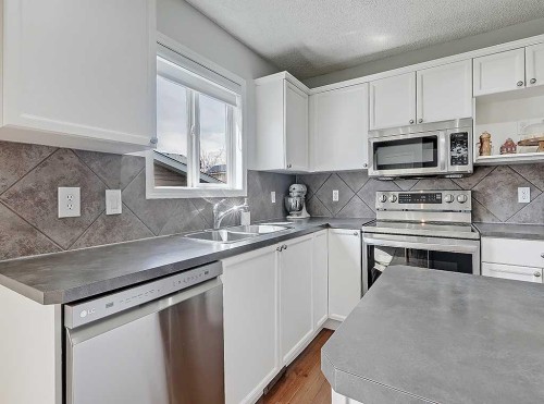 558 Evermeadow Road Sw, Calgary, AB - Indoor Photo Showing Kitchen With Double Sink